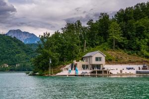 Happyland Villa, Jablanica في Jablanica: منزل على شاطئ البحيرة