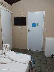 a hospital room with a bed and a door at Portal Cores in Porto De Galinhas