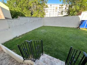 a yard with two benches and a retaining wall at Best holliday Home for family newly renovated in Garges-lès-Gonesse