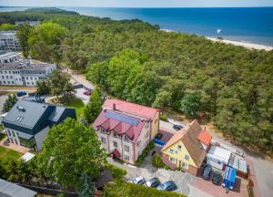 an overhead view of a house with a beach at Willa Dorotka in Dąbki