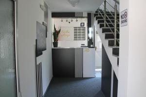 a hallway with a kitchen and a stairway at Villa Marija in Trebinje