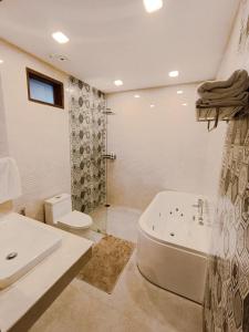 a bathroom with a tub and a toilet and a sink at Q Conzept apt 2br new in Kata Beach