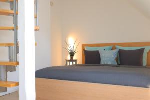 a bedroom with a bed with blue pillows at Watt´n Dog - Urlaub direkt am Nordseedeich in Spieka-Neufeld