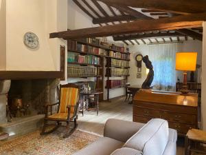 a living room with a couch and a fireplace at Holiday Home Villa il Cesto in Greve in Chianti