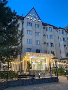 a hotel with a sign on the front of it at Silk Road Lodge in Bishkek