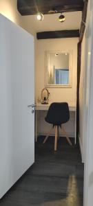 a room with a desk with a chair and a mirror at Ferienhaus Harztörchen in Halberstadt