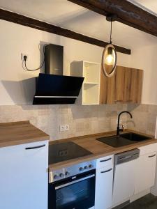 a kitchen with a sink and a stove at Ferienhaus Harztörchen in Halberstadt
