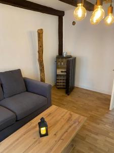 a living room with a couch and a table at Ferienhaus Harztörchen in Halberstadt