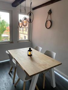 a dining room table with chairs and a candle on it at Ferienhaus Harztörchen in Halberstadt