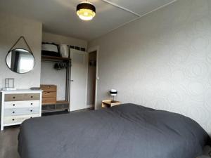 um quarto com uma cama, uma cómoda e um espelho em Appartement Quend, 2 pièces, 3 personnes - FR-1-730-22 em Quend