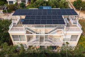 eine Luftansicht eines Gebäudes mit Sonnenkollektoren auf dem Dach in der Unterkunft SunAdria Apartments in Kožino