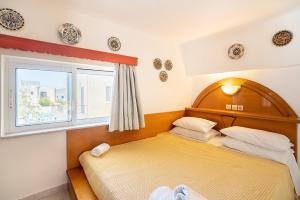 a bedroom with two beds and a window at Olympus Tilos Apt double A1 in Livadia