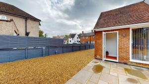 a house with a blue fence next to a building at Mill Stream Passage in Oxford