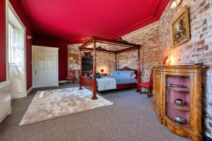 a bedroom with a bed and a brick wall at Finest Retreats - Hickleton Hall Estate in Doncaster