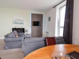 a living room with a couch and a table at 7 Beach View Beaconsfield House in Bridlington