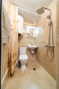 a bathroom with a toilet and a sink and a shower at Abstract Apartment in Varna City