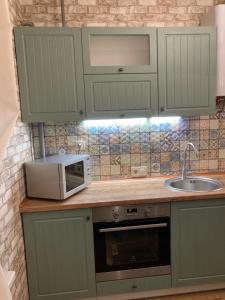 a kitchen with a microwave and a sink at Власне Паркомісце! Апартаменти у новобудові, Городоцька street in Lviv +6 photos