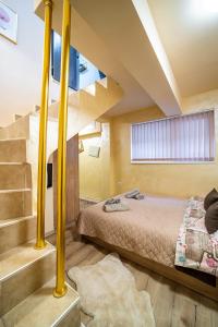 a bedroom with a bunk bed and a staircase at Abstract Apartment in Varna City