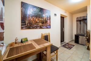 a dining room with a table and a painting on the wall at Abstract Apartment in Varna City
