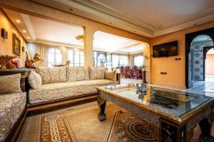 a living room with a couch and a table at Villa Gardens Diafa in Marrakesh