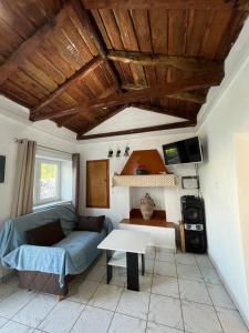 a living room with a couch and a table at Rodovani Cottage in Antipaxos
