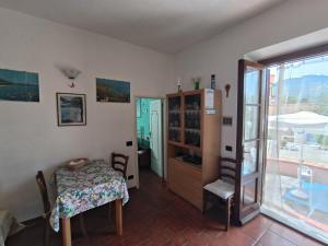a room with a table and a glass door at Primula by Villa Very in Marina di Campo