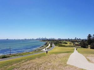 a road leading down to a beach with the ocean at Beachside Getaway on Selwyn in Melbourne