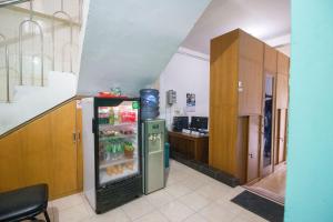 a kitchen with a refrigerator with drinks in it at Halona Residence near Pakuwon Mall Jogja Mitra RedDoorz in Yogyakarta