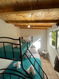 two bunk beds in a room with wooden ceilings at Rodovani Cottage in Antipaxos +1 photo