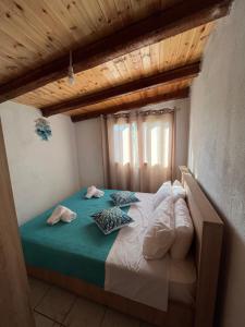 a bed with two pillows on it in a room at Rodovani Cottage in Antipaxos