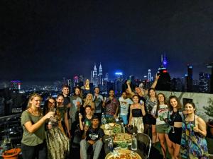 a group of people posing for a picture on a rooftop at The Common Room @ Regalia in Kuala Lumpur