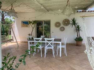 a dining room with a table and chairs at Green Garden Oasi in Cinisi