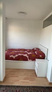 1 dormitorio con 1 cama con manta roja en 1,5 Zimmerwohnung in Heidelberg, en Heidelberg