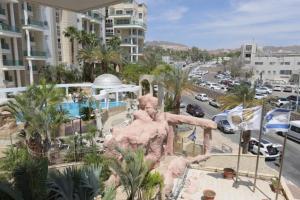 a statue of a man on a city street at Modern 2BR APT Golf Residence in Eilat