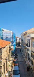 a street with parked cars in a city with buildings at Αργέντη in Chios