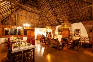 a large room with tables and chairs in a building at Karatu Tented Lodge in Karatu