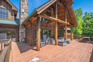 a log cabin with a deck with a patio at Family Sanity in McHenry
