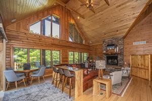 a log cabin with a living room and a fireplace at Family Sanity in McHenry
