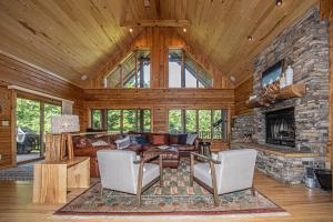 a living room with a stone fireplace in a log cabin at Family Sanity in McHenry
