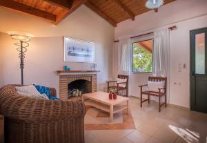 a living room with a couch and a fireplace at Lofos Soilis in Tragaki