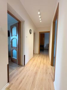 an empty room with two doors and a wooden floor at 15 Gdynia Centrum - Apartament mieszkanie dla 7 osób in Gdynia
