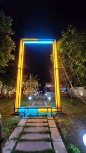 a lit up arch in a park at night at Sky Frame Beach Resort in Varkala