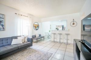 a living room with a couch and a table at Modern 2 Bedroom in the Heart of Wynwood Art District in Miami