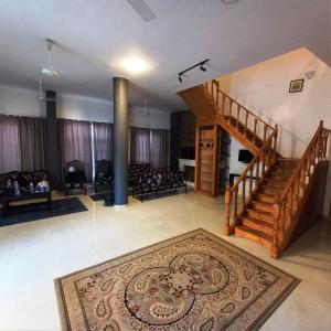 a living room with a staircase and a rug at Ali Luxury Villa in Luxor