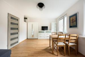 a dining room with a table and chairs at Ochota Standard Apartment in Warsaw