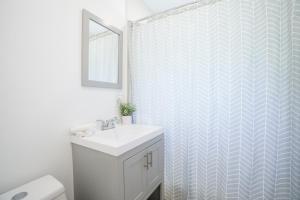 a bathroom with a white sink and a shower at Modern 2 Bedroom in the Heart of Wynwood Art District in Miami