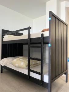 a black bunk bed with blue lights on it at ALBERGUE CASTELOS VILALBA in Villalba