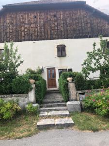 a house with a staircase leading up to a door at L’ABSINTHE in Bannans