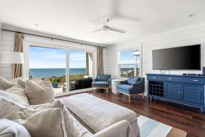 a living room with a couch and a flat screen tv at The Good Life in Inlet Beach