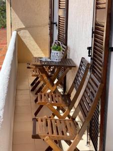 stół i 2 krzesła na balkonie w obiekcie Kommeno Bay Apartments w Korfu